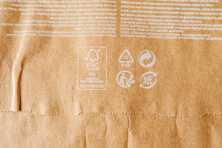 RUSSIA, UFA - NOVEMBER 02, 2020: Closeup of bag, full recycled craft paper with white lettering of recycling signs.のeditorial素材
