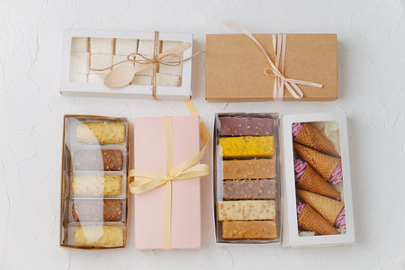Variety of sweets. Chocolate bars, waffle cones with zefir and turkish delight in windowed and...
