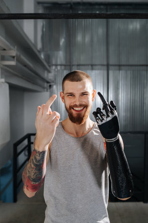 Free spirited cyborg man left showing middle finger with bionic and normal handsの写真素材