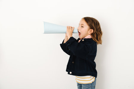 Little girl screams in loudspeaker, curled into a cone sheet of paper
