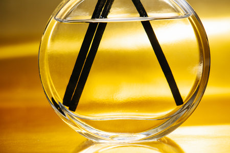 abstract gold through a glass flask with aromatic sticksの写真素材