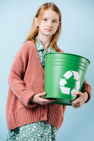 Red-haired girl volunteer advocating for recycling and clean planetの写真素材