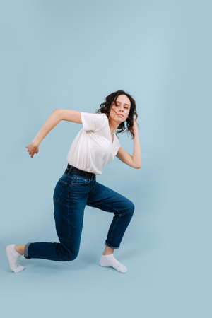 Thoughtful contemporary dancer portraing running man, holding her body lowの写真素材