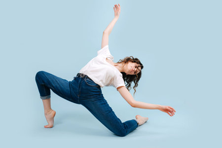 Hard working contemporary dancer with body twisted. Shes arched, looking back.