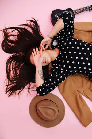 Girl lying on the floor, she covering her eyesの写真素材