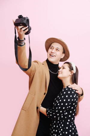 Young couple in love takes selfie, snuggled up to each otherの写真素材