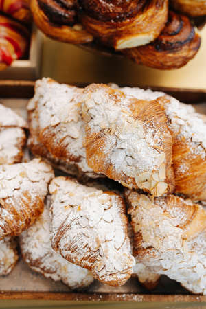 Sprinkled pastry with almonds in a pile. close up. Looking appetising, shade of gold.の写真素材