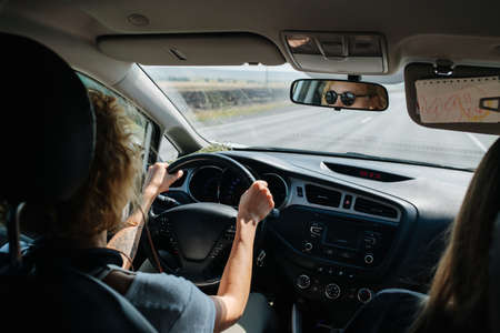 High angle backseat view of a woman driving her car.の写真素材
