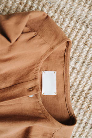 Piece of brown clothes on the floor carpet. Neck part, top view.の写真素材