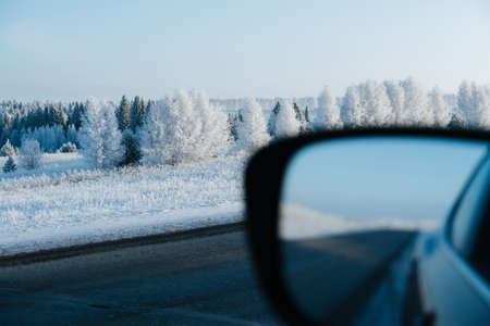 Stunning winter landscape by the road taken from the car. Icy trees and grass. Air moisture condensed on branches because of the cold weather.の写真素材