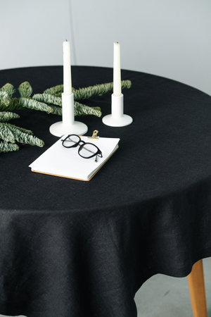 Low angle image of an artificial tree on a round table with a black tableclothの写真素材