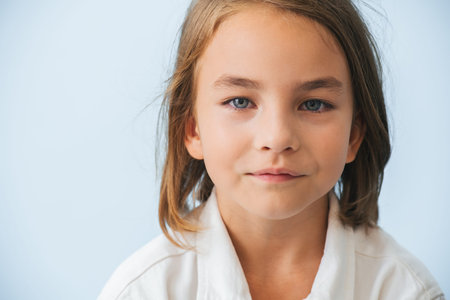 Close up portrait of an eight year old girl looking at the camera