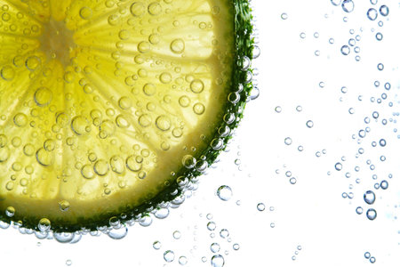 fresh lime slice in water with bubbles