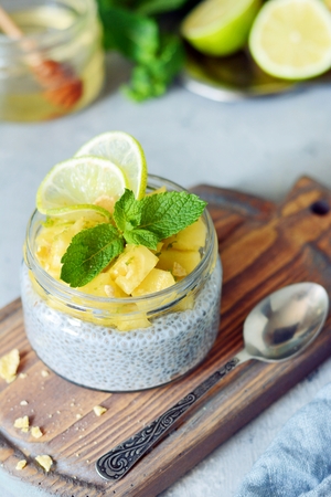 Breakfast table with chia fruit, smoothies, honey and mint leaves. Healthy food. Top view, blank spaceの写真素材