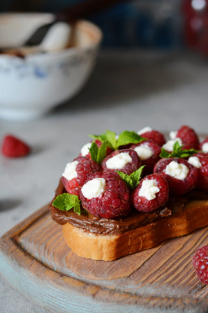 Delicious toast with cheese and raspberries