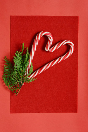 Background with heart sprig of fir. Christmas sweets. Romantic card, caramel heart. Valentine's Day.
