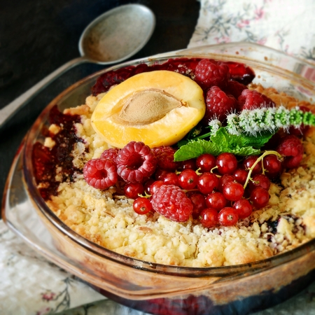 Berry crumble, crisp in baking dish on a dark background. Top view.Delicious light American dessert.の写真素材