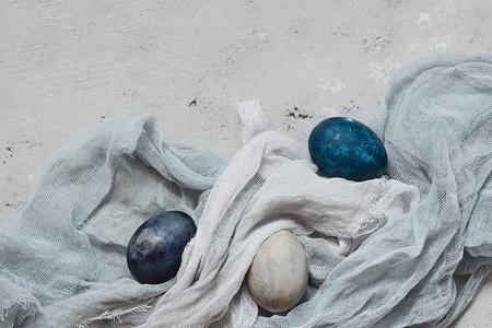 Dyed Easter vintage eggs with scuffs on a light gray background. Stylish Background with easter eggs, modern. Happy Easter card.の写真素材