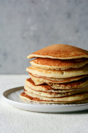 Sweet Homemade Stack of Pancakes for Breakfast on a gray background. Sweet beautiful breakfast....