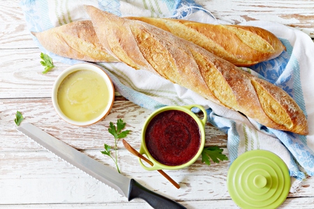 Fresh crispy French baguette with chicken liver pate and berry marmalade on a white aged background. Fresh homemade chicken pate on breadの写真素材