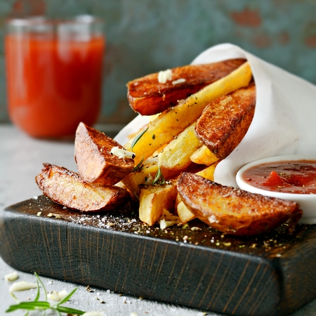 Potato food. Baked potatoes with spices and salt. Ketchup and tomato juice.の写真素材