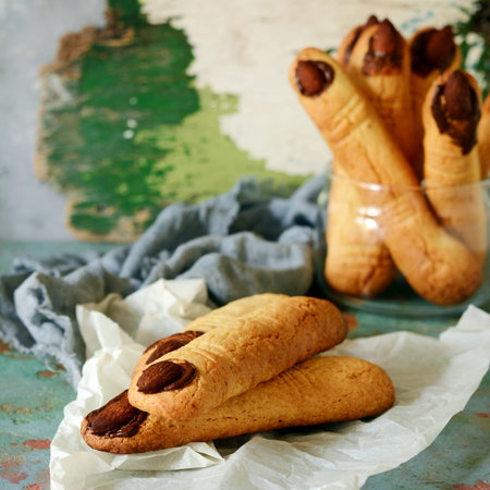 Halloween witch's fingers cookies, funny recipe for Halloween party. Homemade cookies in form of...