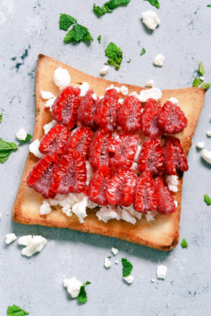 Toast with fruit raspberry, mint and cottage cheese for breakfast. Healthy breakfast, Ruddy bread...