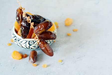 Bowls with juicy dates on a gray-blue background. Healthy tasty food, snackの写真素材