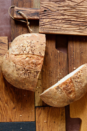 Homemade Freshly Baked Country Bread made from wheat and whole grain flour on a gray-blue...