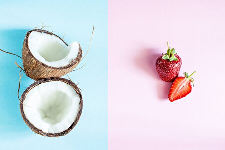 Ripe coconut with fresh strawberries on a pink-blue background. Summer fruits, healthy eating concept. Useful to the body, Healthy concept and Spa Concept.の写真素材