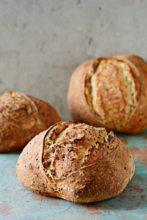 Homemade Freshly Baked Country Bread made from wheat and whole grain flour on gray background. French Freshly baked bread.の写真素材