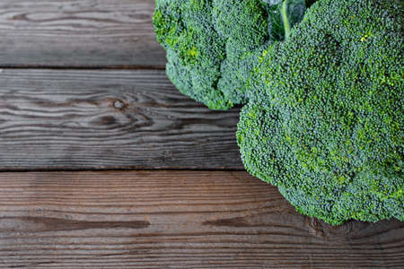 Ripe organic raw broccoli on wooden background with place for text, copy spaceの写真素材