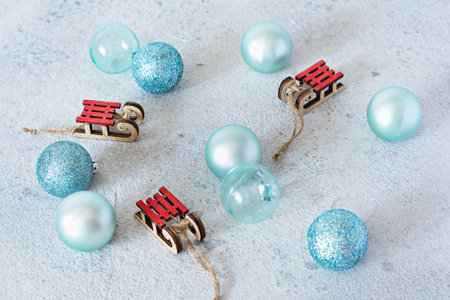 Decorative wooden sled with the inscription Merry Christmas and blue balls for decorating the...