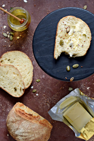 Fresh homemade yeast-free bread made from whole grain (rye) flour with bran, cereals and seeds with...