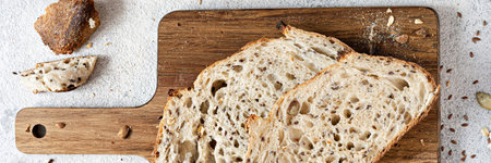 Fresh homemade bread (slice) from whole grain sourdough flour with the addition of bran, seeds...