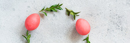 Easter wreath of pine needles, boxwood and painted eggs on light background. Festive concept, top view, copyspace.の写真素材