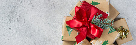 Many small gift boxes with a large red box in the center, wrapped in holiday paper on a white (gray)...