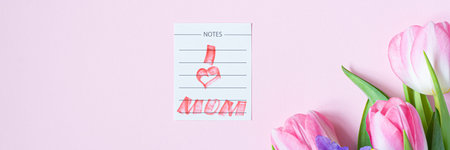 Bouquet of pink tulips and irises on pink background. Greeting card for mother's day, women's day...