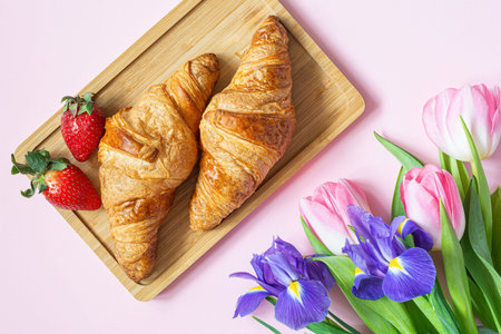 Happy mother's day, Valentine's Day, beautiful breakfast, lunch with  fresh croissants, strawberries on tray, bouquet of tulips as gift.の写真素材