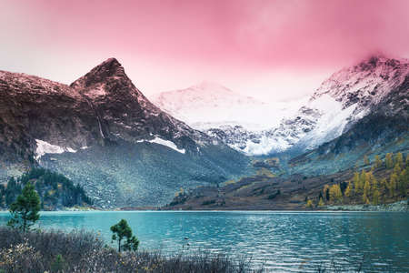 Mountain lake with reflection in the mirrored surface of the rocks. The beauty of the mountain country and nature.