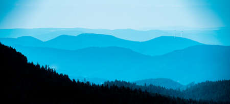 Amazing mystical rising fog mountains sky, black silhouette of forest trees landscape view in black forest ( Schwarzwald ) winter, Germany panorama panoramic banner - mystical snow foggy mood