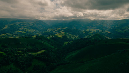 A breathtaking view of lush green hills unfolds, capturing the serenity of the French Pyrenees. High quality photo