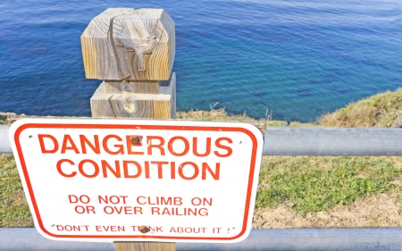 Dangerous condition Bold red letters on a white hazard sign atop a ...