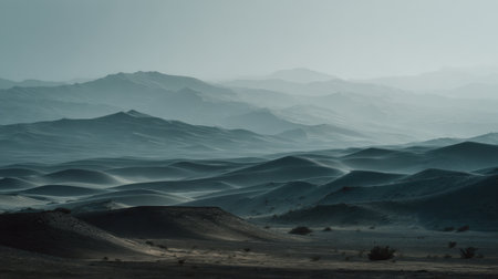 Captivating desert landscape featuring soft-rolled sand dunes extending to distant mountains, capturing the essence of tranquility and natural beauty in a serene atmosphere.