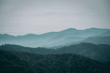 A foggy mountainous scenery under the gloomy sky